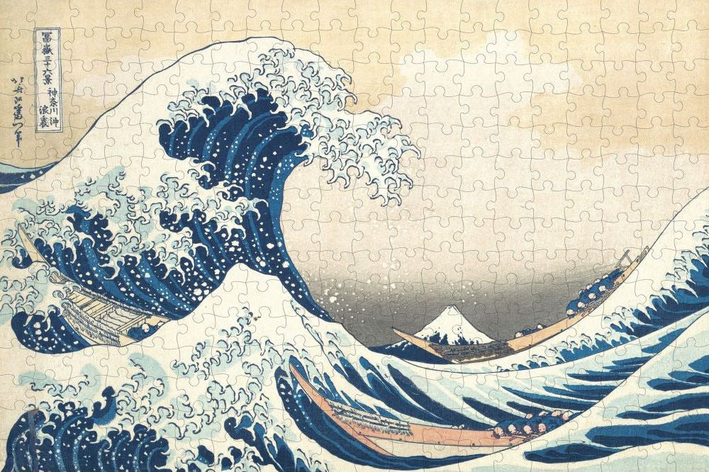 Jigsaw puzzle with a design of a large wave and mountain, inspired by famous artwork.