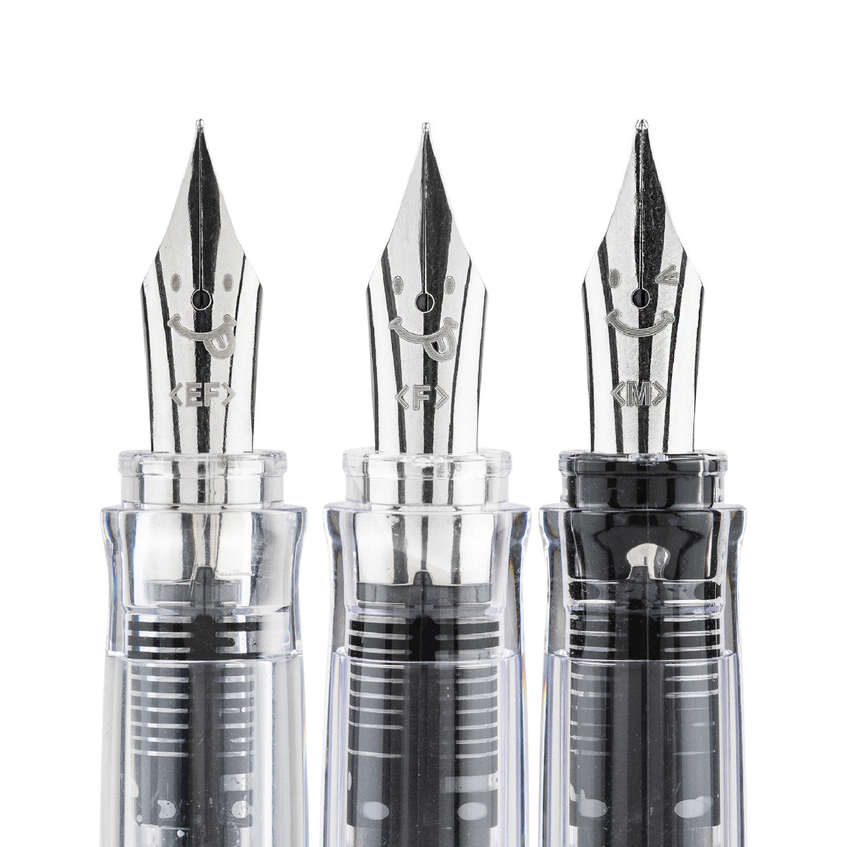 Three fountain pen nozzles with transparent bodies on a white background