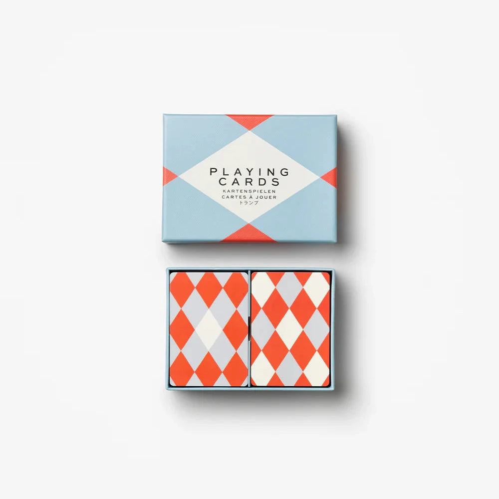 Two sets of playing cards with geometric designs on a white background