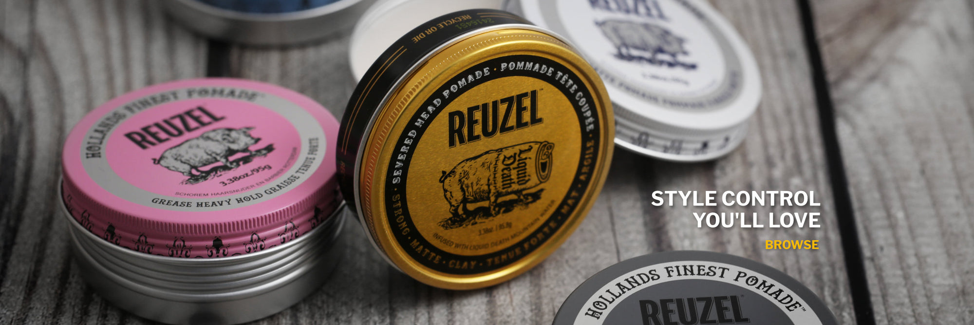 Reuzel Pomade tins on a timber background