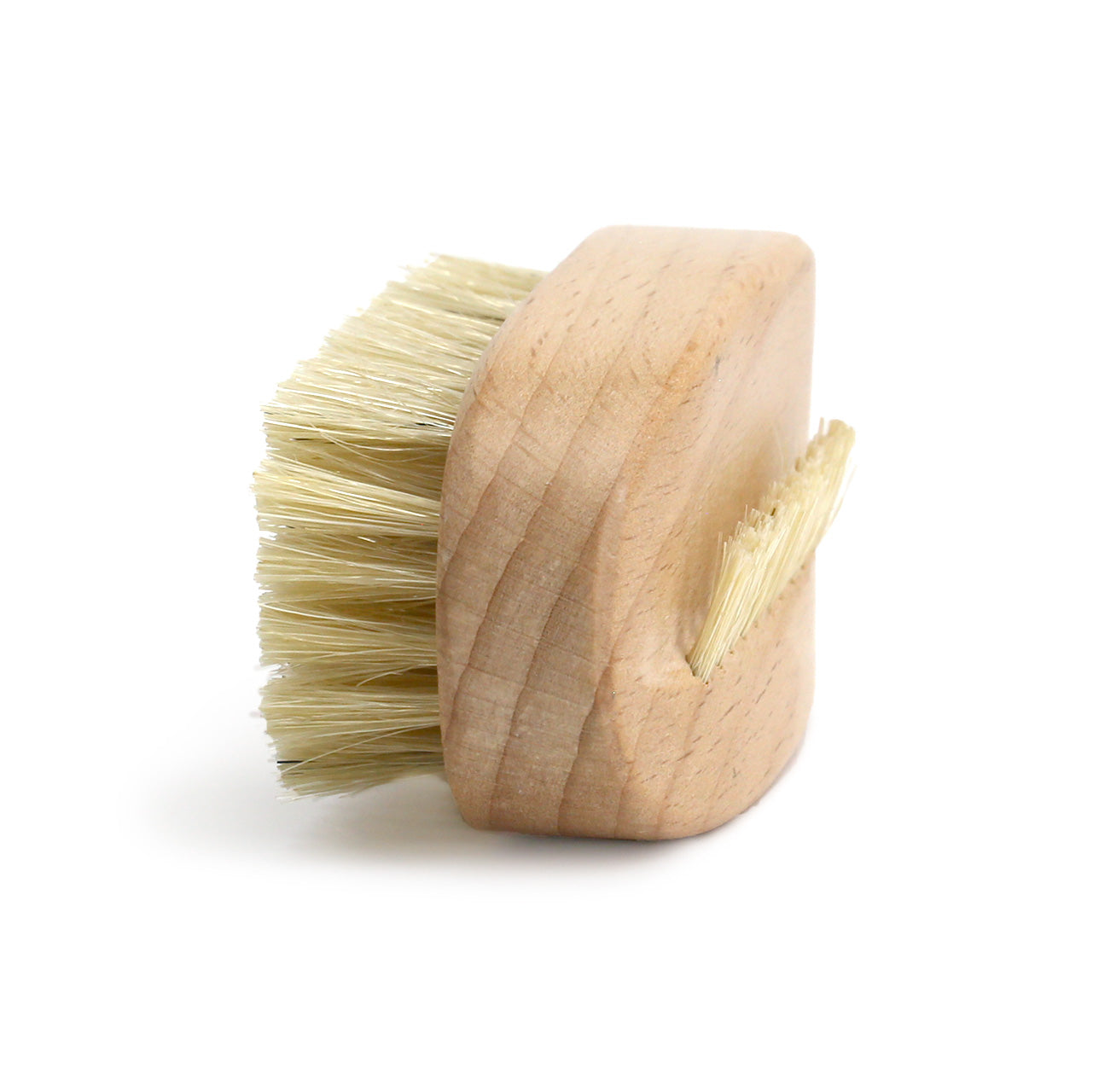 Natural colured timber nail brush  with stiff boar hair bristles - three quarter view of long edge and top