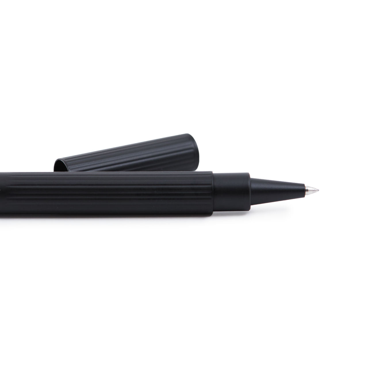 black rollerball with removed cap sitting at a slight distance