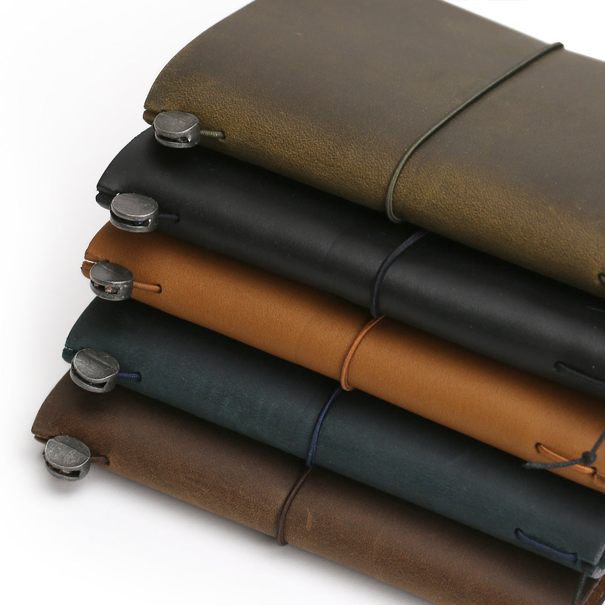 Colour comparison of leather notebooks from bottom, brown, blue,Camel, black and Olive 