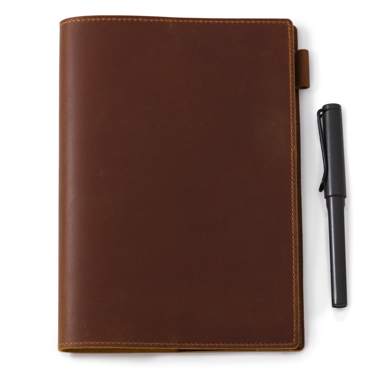 Brown leather notebook cover seen closed with the penloop visible at the side