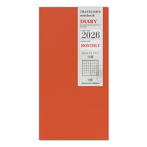 Orange coloured Traveler's Notebook Monthly Diary refill with a white label displaying '2026 Diary Monthly' on a white background