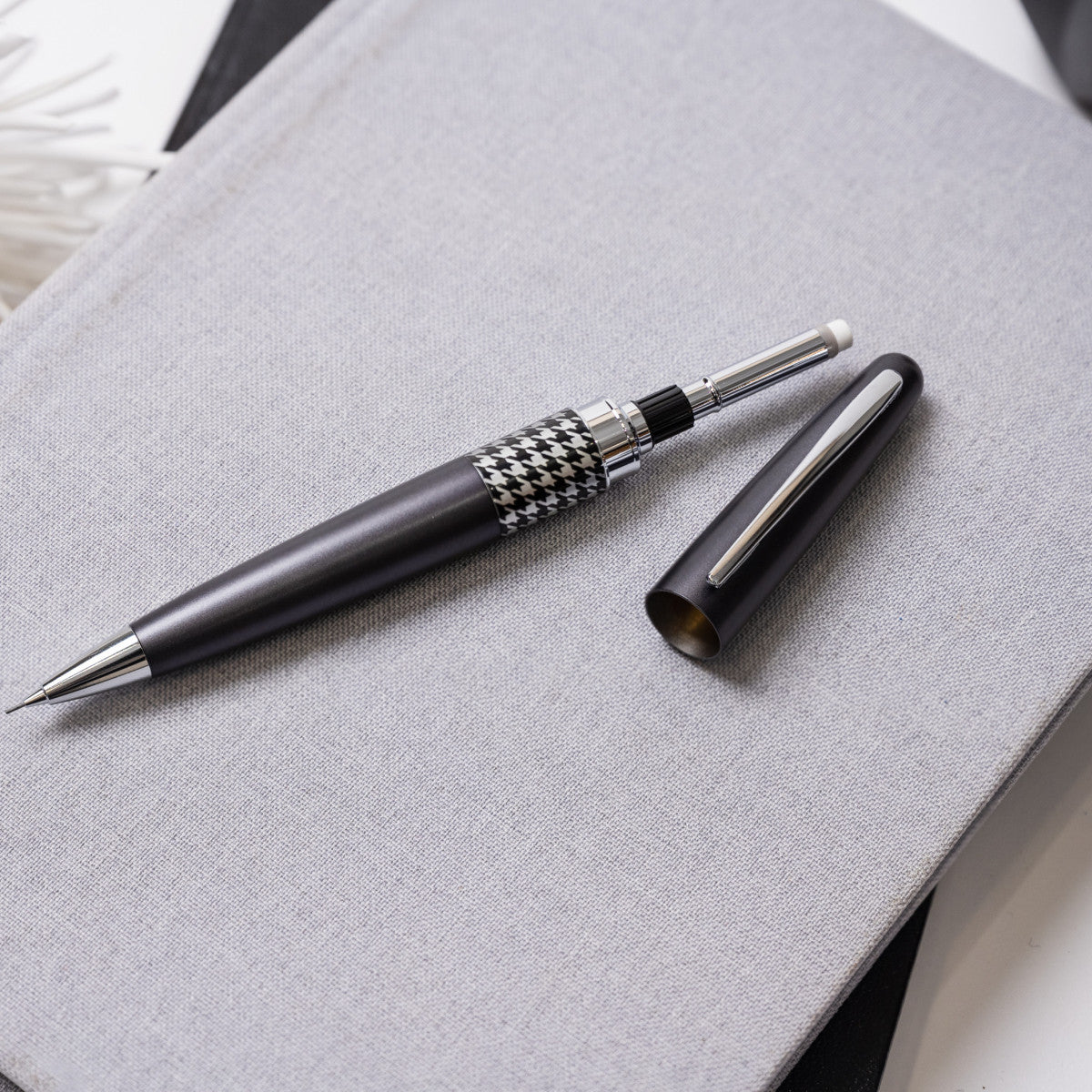 Pen with houndstooth pattern on a gray surface