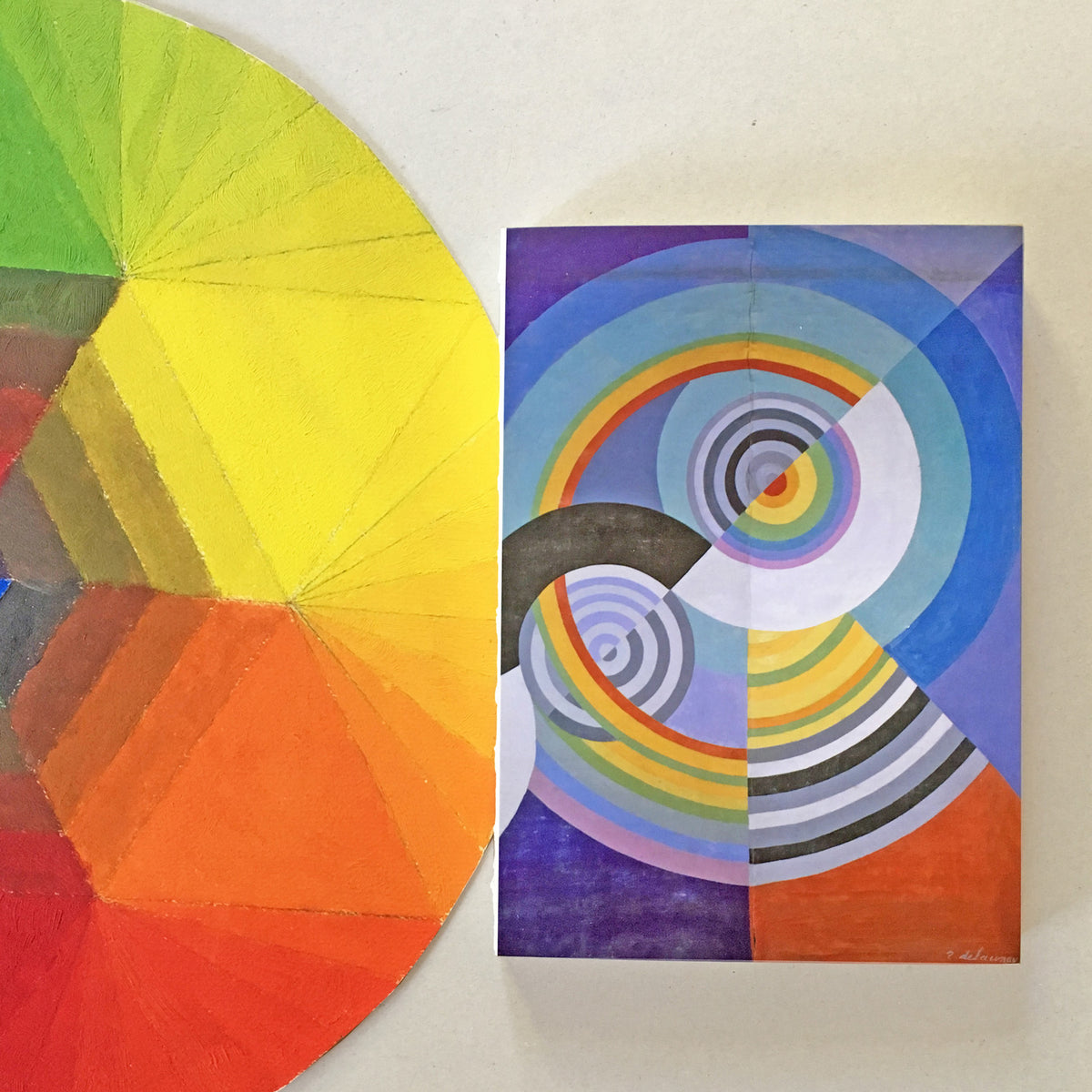 Color wheel and abstract art piece with concentric circles on a white background