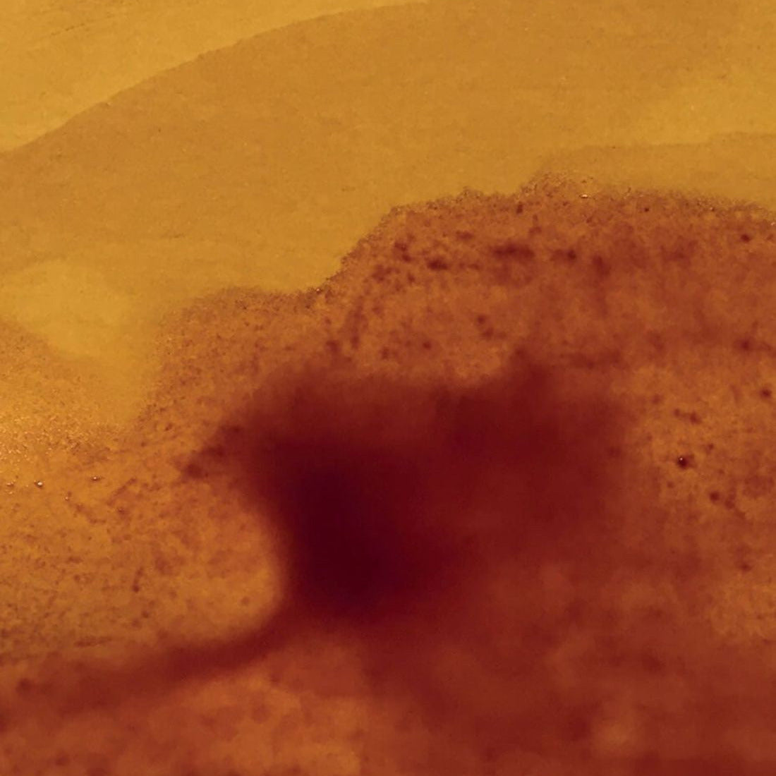 Dust cloud in a desert landscape with rolling sand dunes
