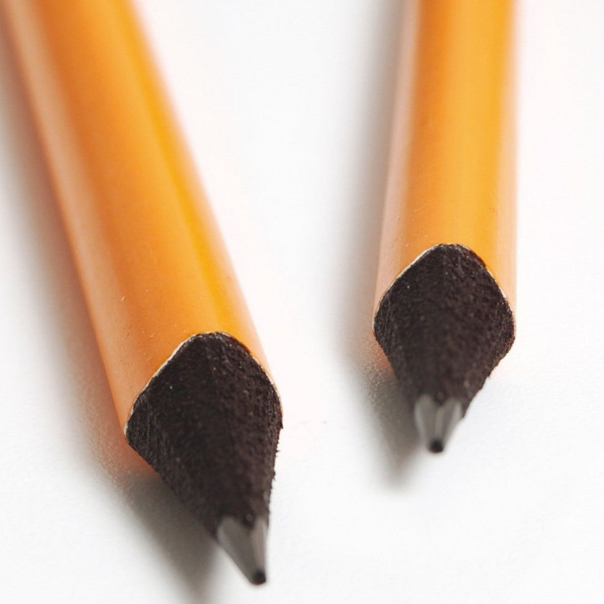 Two pencils with eraser caps on a white background