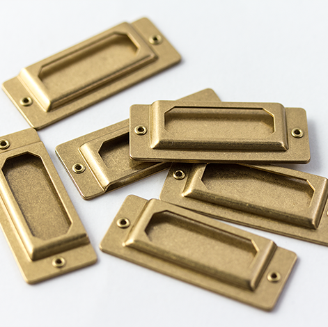 Set of brass cabinet handles on a white background