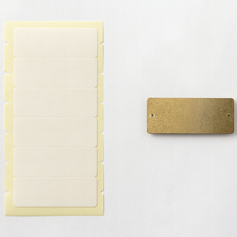 Rectangular beige object with a gold rectangular component on a white background