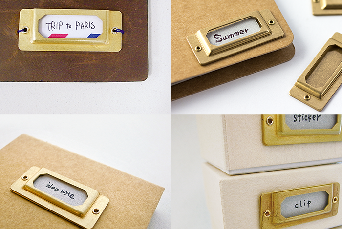 Gold nameplates on various cardboard boxes with different labels.