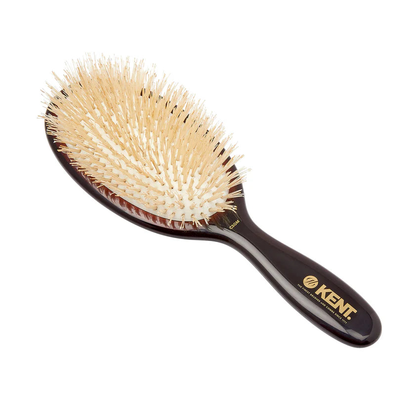 Kent hairbrush with black handle and beige bristles on a white background
