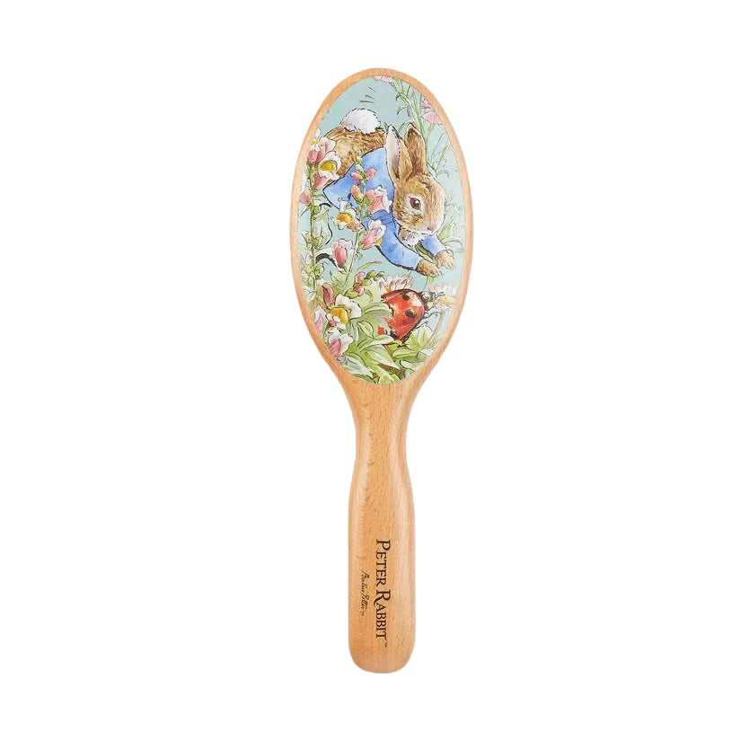 Wooden hairbrush with Peter Rabbit design on a white background