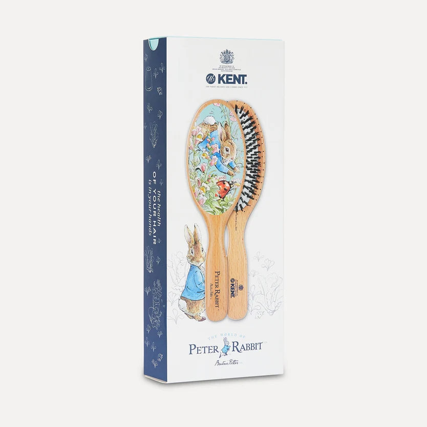 A boxed set of two Kent brand hairbrushes featuring Peter Rabbit illustrations, shown in its retail packaging against a light gray background.