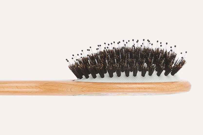 Bamboo toothbrush with black bristles on a white background