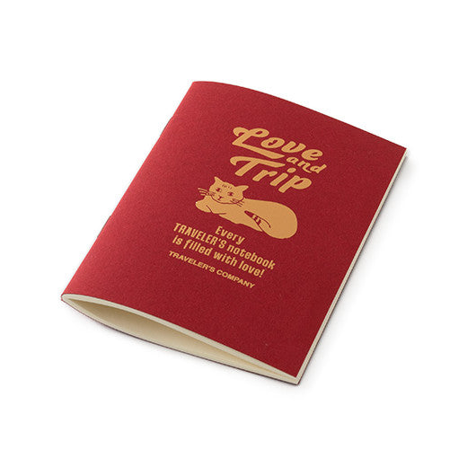 a three quarter view of the Love and Trip refill notebook which has a red cover and blank cream pages
