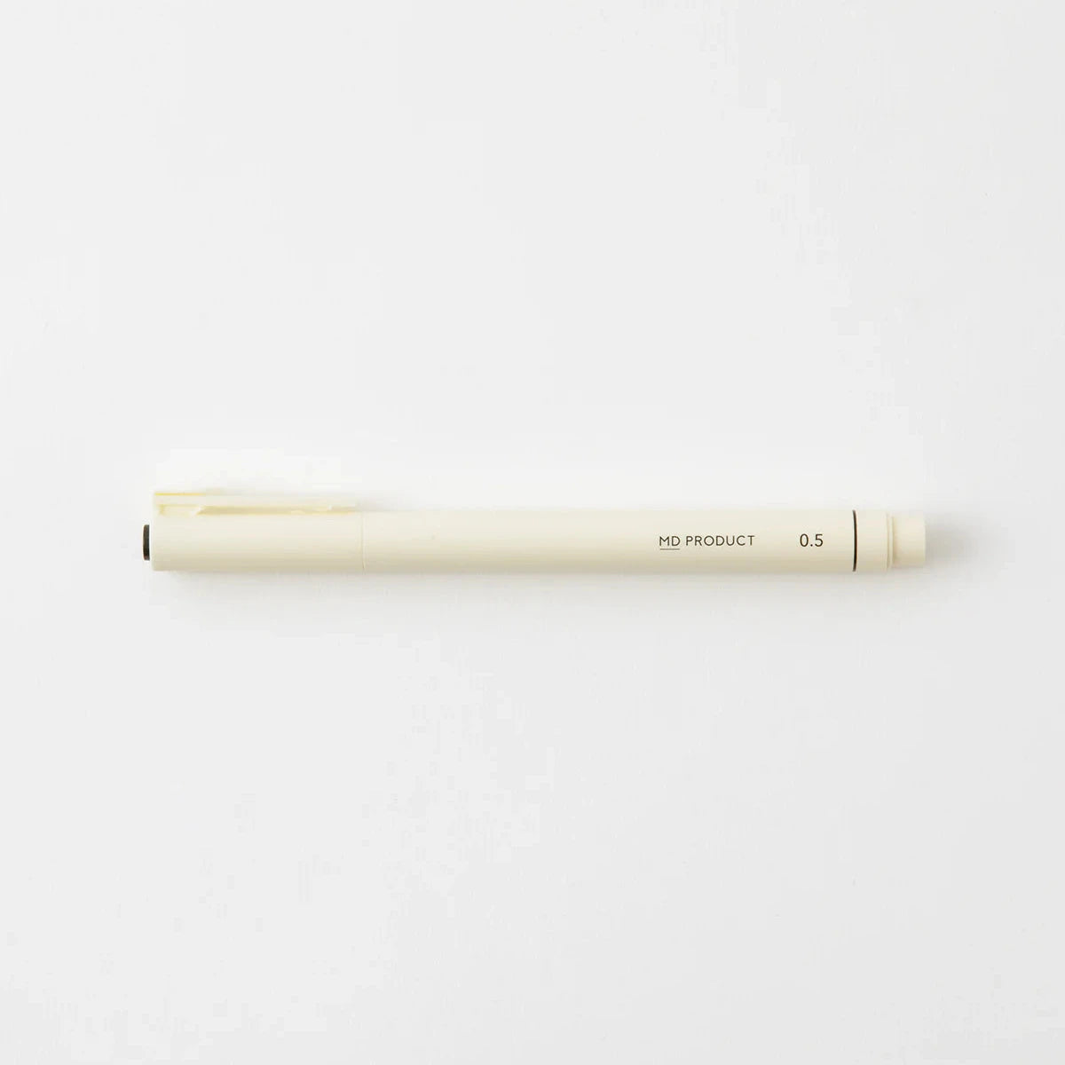 White pen with gold accents on a light gray background