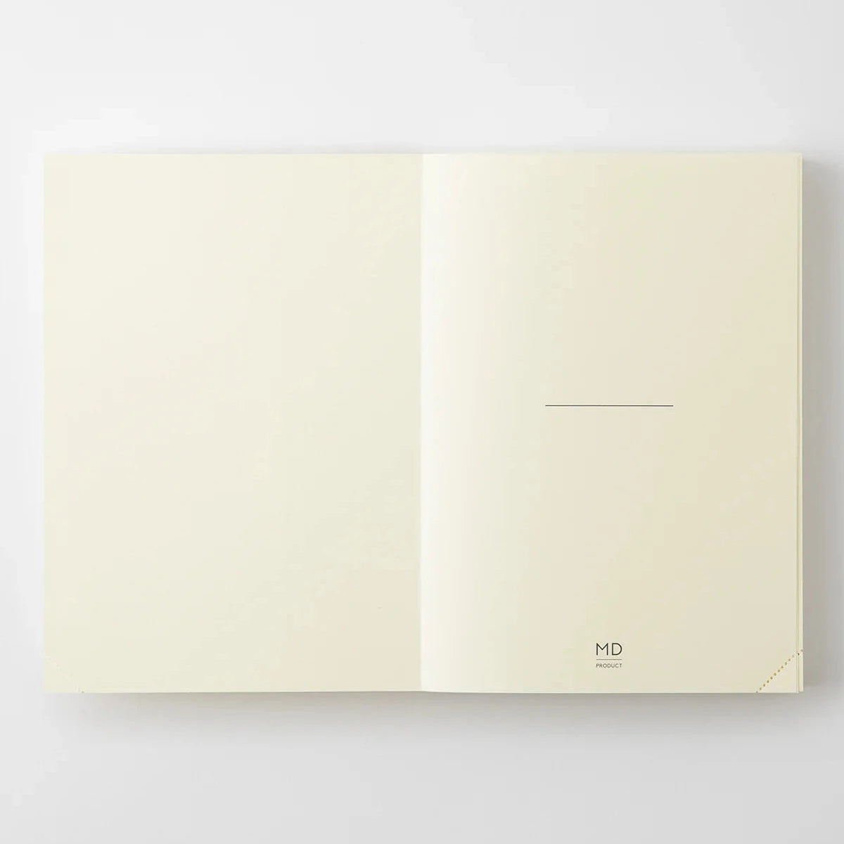 Open beige notebook with 'MD' branding on a white background