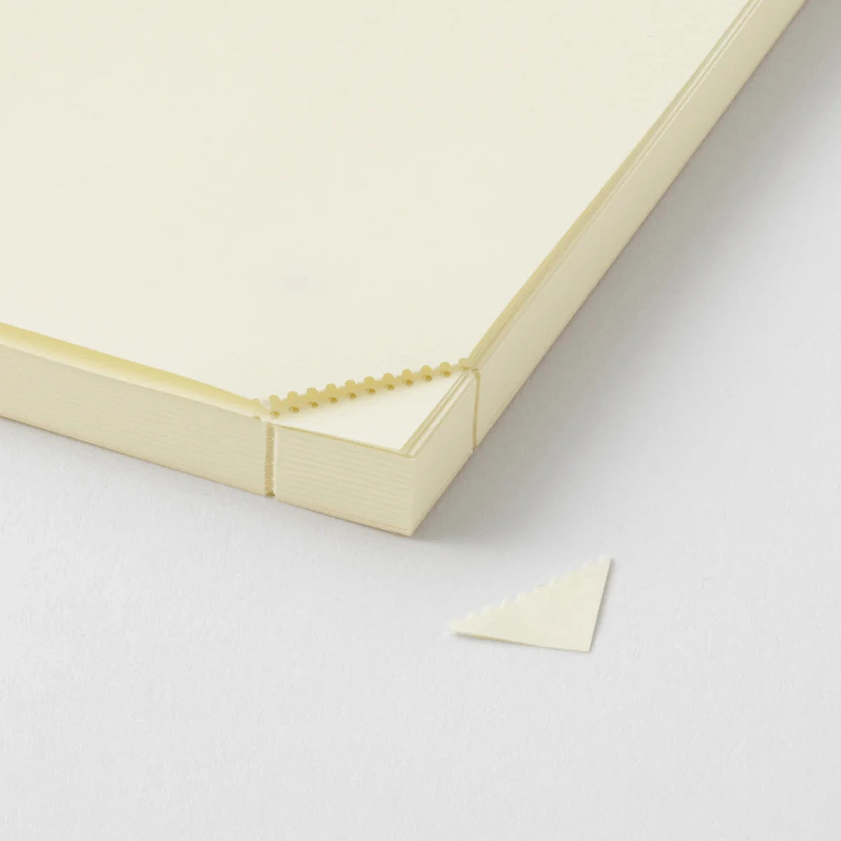 Close-up of a beige corner of a box on a light gray background