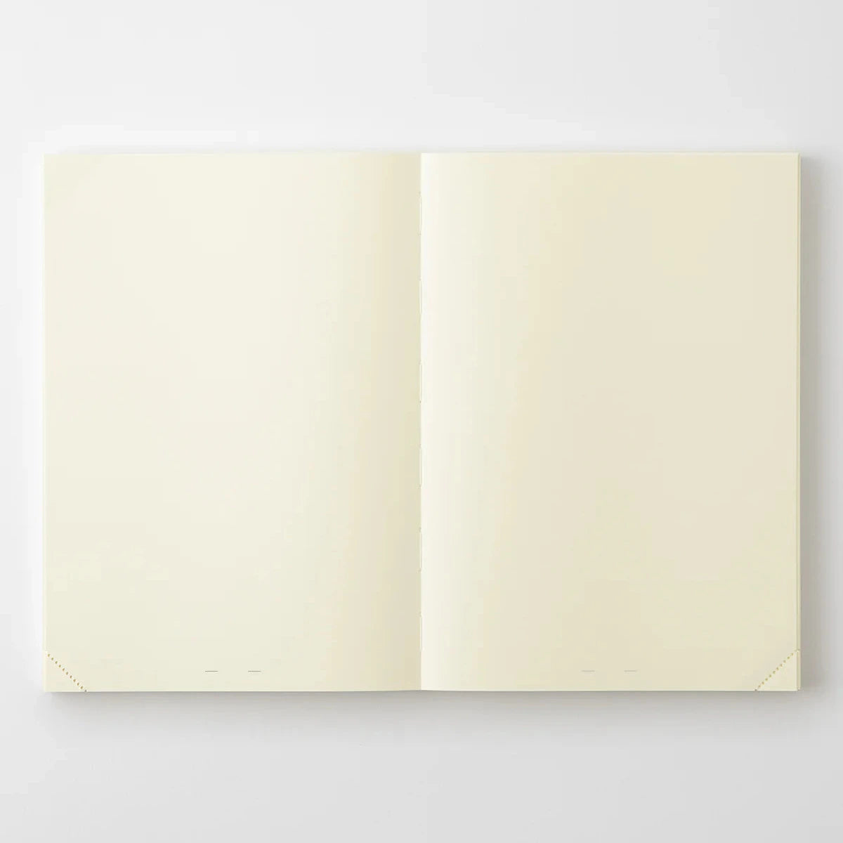 Open notebook with cream-colored pages on a white background