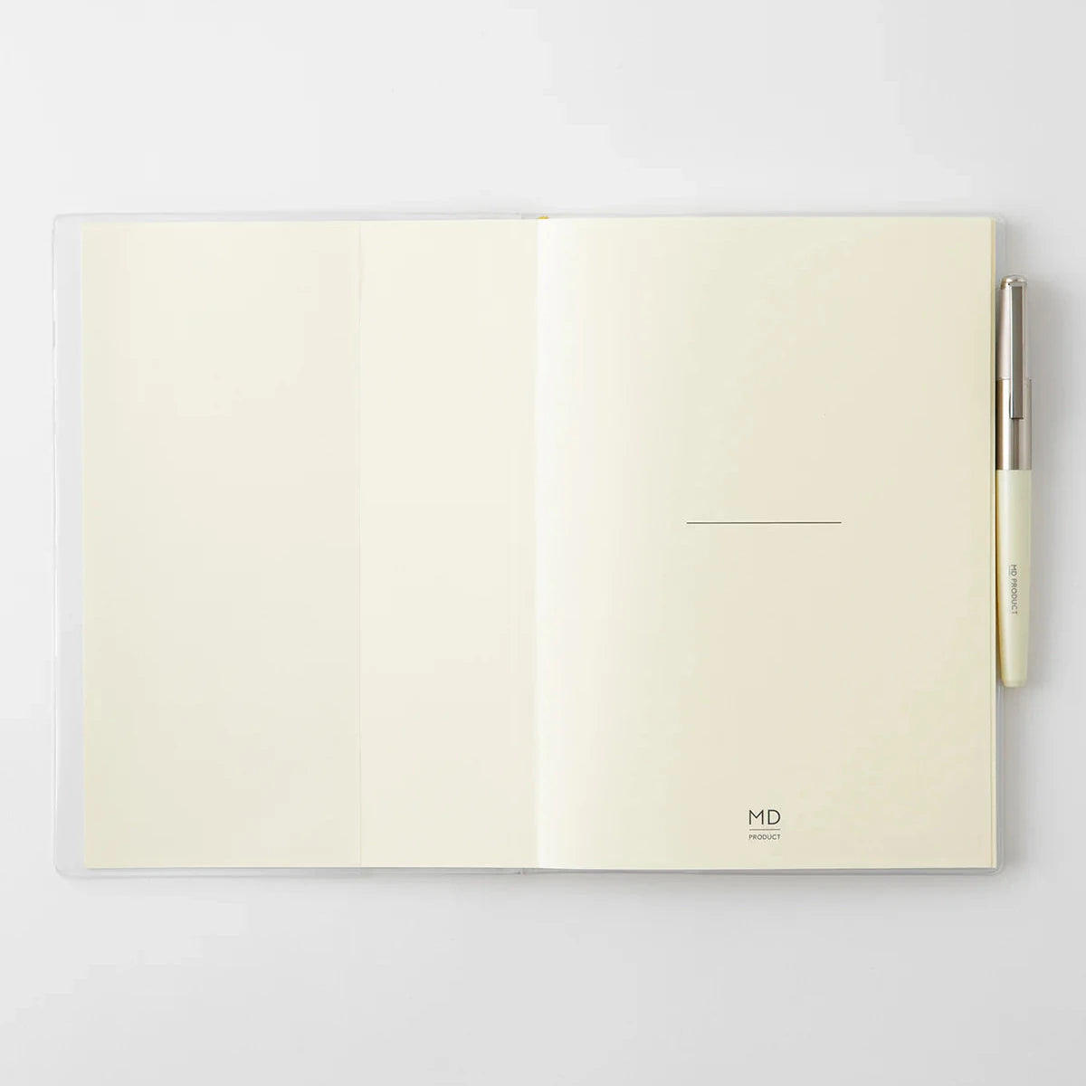 Open notebook with cream-colored pages on a light gray background