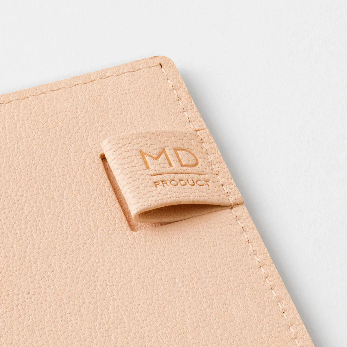 Beige product with a logo on a light gray background