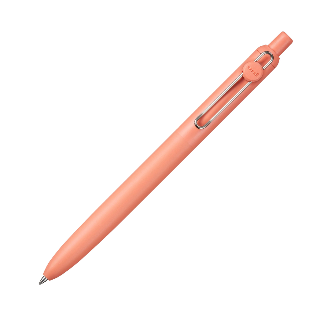 Peach-colored pen with a metal clip on a white background