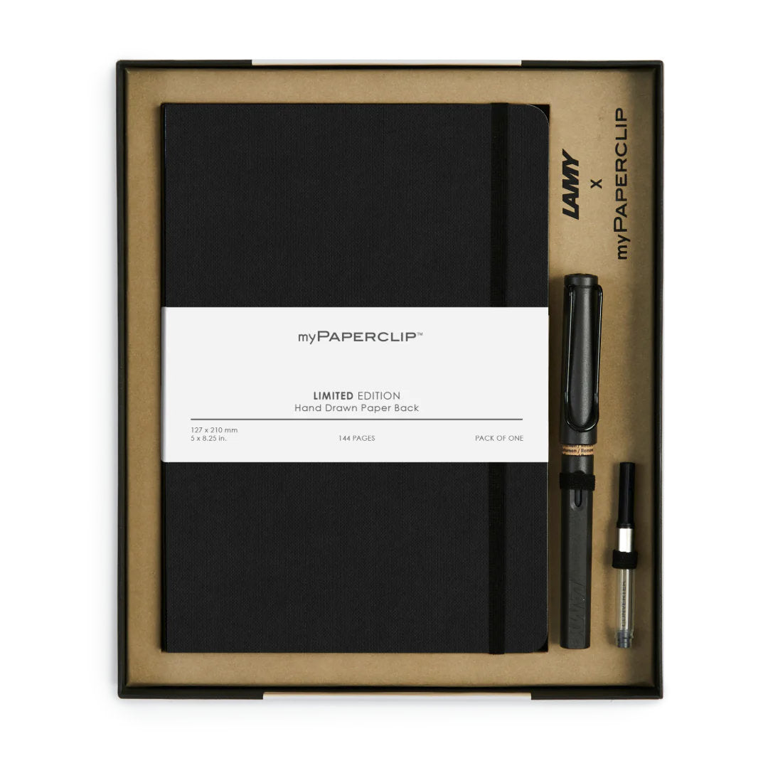 Top-down view of inside the LamyxMyPaperclip gift set showing an A5 notebook, a Lamy charcoal fountain pen and converter in a taupe coloured insert and black box