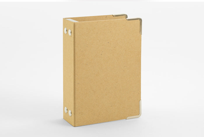 A kraft board Traveler's Notebook passport refill binder with the label '016 TRAVELER'S notebook' on the cover.