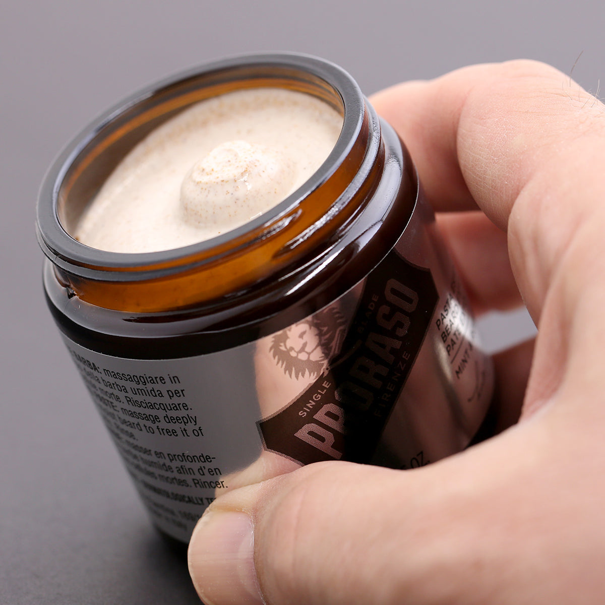 Proraso Beard Exfoliant - a view of the product inside the open jar held in a man&#39;s hand