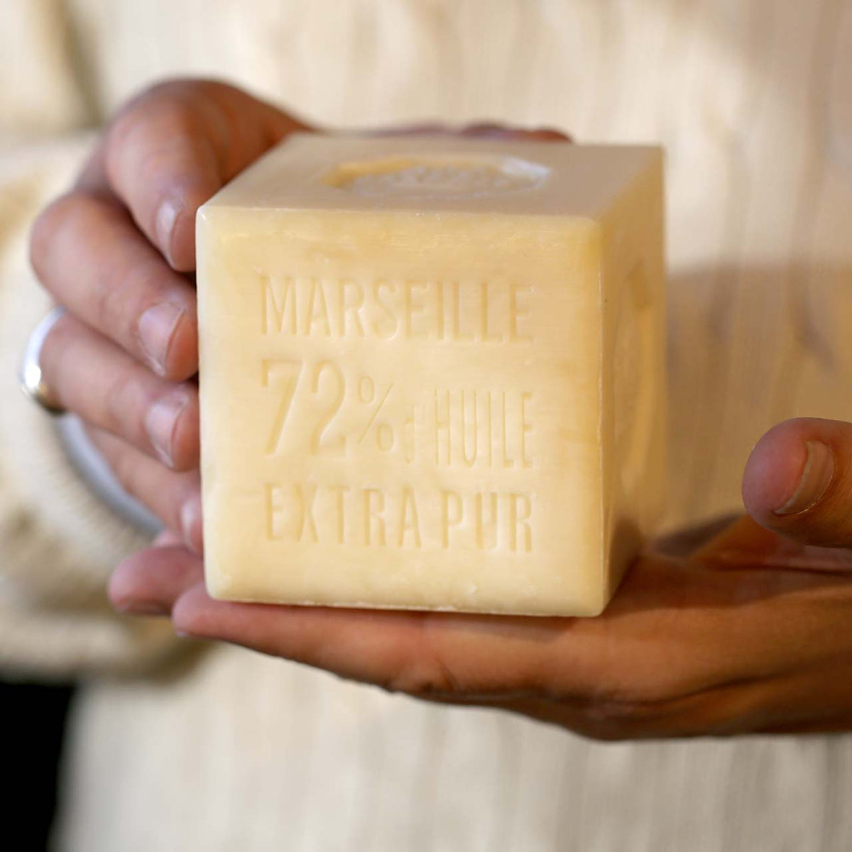 Close-up of man holding the 600g block of soap for relative size reference.