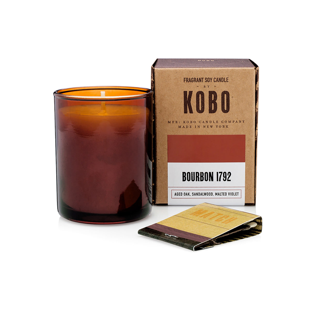 Kobo Pure Soy votive candle in an amber glass jar with ceramic matches and kraft box. Bourbon 1792 scent