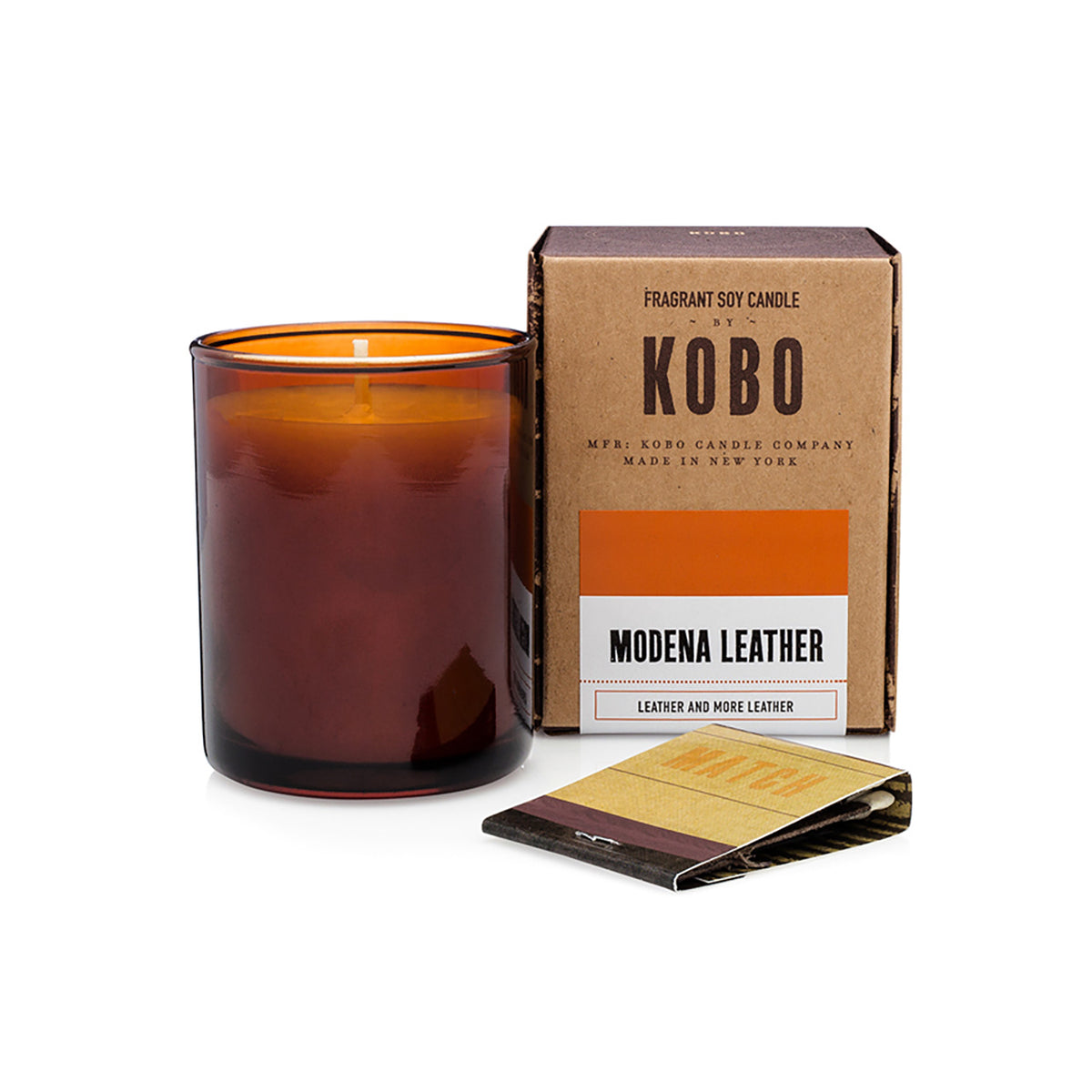 Kobo Pure Soy votive candle in an amber glass jar with ceramic matches and kraft box. Modena Leather scent