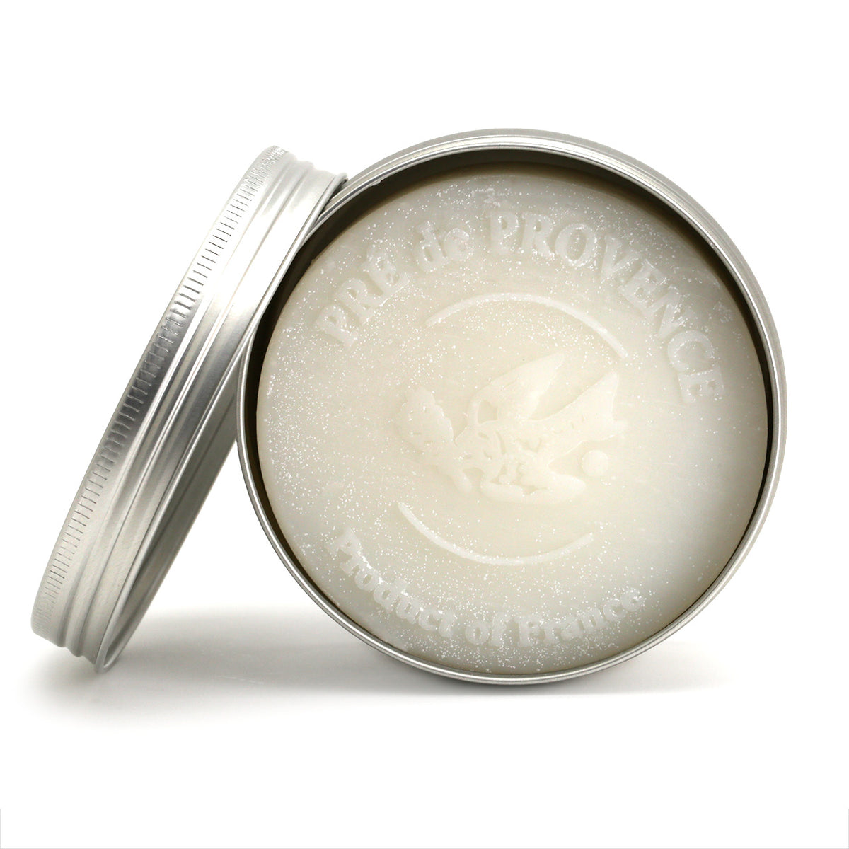view of the top of the white shaving soap puck, inside the tin
